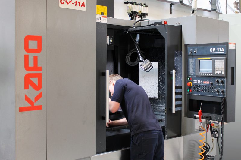 Employee working on CNC machine